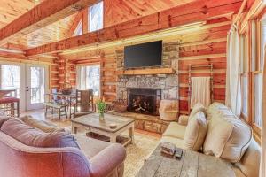 a living room with a fireplace in a log cabin at 2 Bed 2 Bath Vacation home in Whittier in Whittier