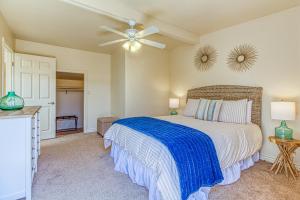 a bedroom with a bed and a ceiling fan at Ocean Beach Cliffs Sanctuary Oceanfront cottage w/unobstructed views & deck: steps to the water in San Diego