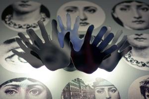 a display of hands on a wall with posters at Hôtel du Triangle d'Or - Proche Madeleine in Paris