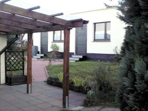 a pergola in the backyard of a house at Haus Amira in Gager