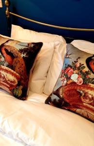 two pillows sitting on top of a bed at 20 Market Place Coleford in Coleford