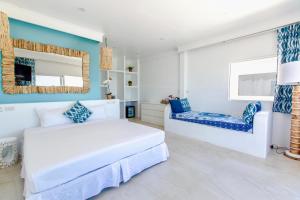 a bedroom with a white bed and a blue wall at So KohKoon Beach Resort in Bang Rak Beach