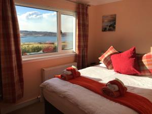 a bedroom with a bed with a large window at Corran House in Kingsburgh