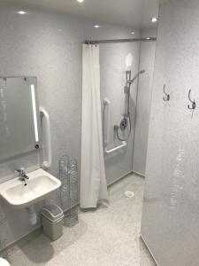 a bathroom with a shower and a sink at Bayview Cottage, in Thurso