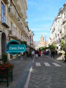 a street in a city with people walking down the street at Casa Zara Sorrento City Center in Sorrento