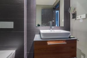 a bathroom with a sink and a bath tub at Hotel Cismigiu in Bucharest