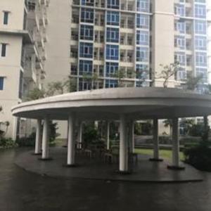 a pavilion with tables and chairs in front of a building at Capitol Park Residence salemba-cozy room in Jakarta