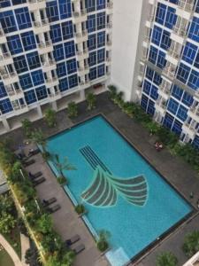 an overhead view of a swimming pool with tall buildings at Capitol Park Residence salemba-cozy room in Jakarta