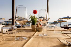 a table with three wine glasses on top of it at Hotel Ristorante Il Gabbiano in Cecina