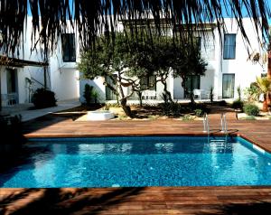 a swimming pool in front of a building at Sa Cala Suites in Es Caló