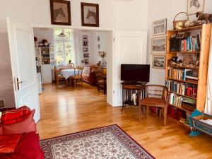 a living room with a couch and a television and a table at Villa Anna in Zinnowitz