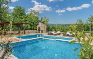 a swimming pool in a backyard with a gazebo at Villa Maslina in Imotski