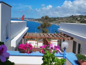 a view from the balcony of a house with flowers at Casa Baia smeraldo in Leuca