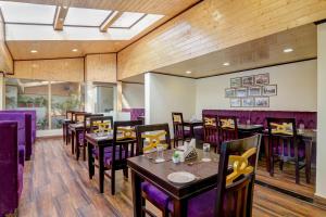 a dining room with tables and purple chairs at Sumitel Darjeeling in Darjeeling