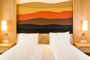 1 dormitorio con 2 camas y un cuadro en la pared en Hotel Hasslhof, en Caldaro