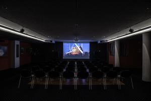 a room with chairs and a large screen at Hotel Montana in Vason