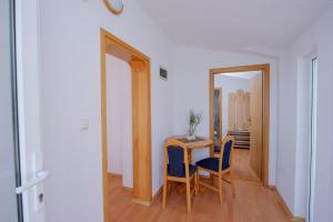 a dining room table with two chairs and a mirror at Pension Maric Rooms in Brist