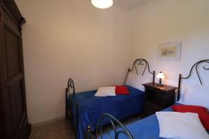 A bed or beds in a room at Masseria Fagà