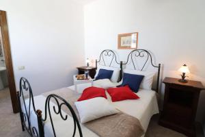 A bed or beds in a room at Masseria Fagà
