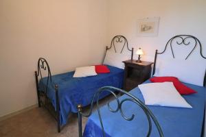 A bed or beds in a room at Masseria Fagà