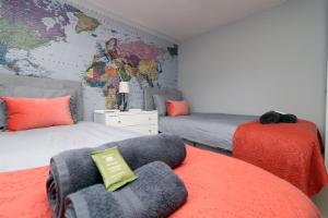 a bedroom with two beds and a map of the world at Home from Home by StayStaycations in Quedgeley