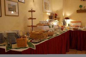 a table with baskets of bread and plates on it at Landhotel Keils Gut in Wilsdruff