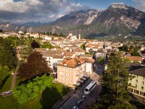 an aerial view of a city with mountains in the background at Hotel Terme Villa Regina in Levico Terme
