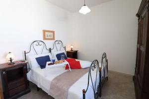 A bed or beds in a room at Masseria Fagà