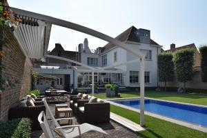 a large room with a pool and chairs in it at B&B Casa Romantico in Bruges