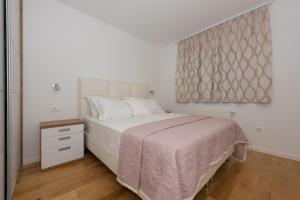 Postel nebo postele na pokoji v ubytování Penthouse Jure