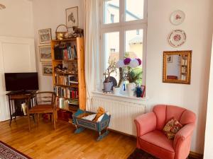 a living room with a chair and a window at Villa Anna in Zinnowitz