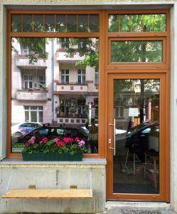 a window with a bench and flowers in front of it at Minimal Hostel No 41 in Berlin