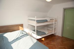 a room with a bed and a shelf with towels at Apartment Polane in Blejska Dobrava