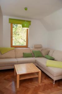 a living room with a couch and a table at Apartment Polane in Blejska Dobrava