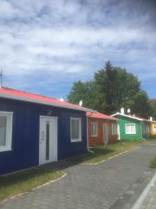 a row of colourful houses on the side of a road at Havel Marin GmbH in Brandenburg an der Havel