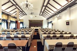 a room with rows of tables and chairs in a hall at Buraphat Resort in Chiang Dao