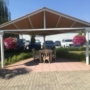 a pavilion with a table and chairs on a patio at Havel Marin GmbH in Brandenburg an der Havel +2 photos