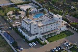 an aerial view of a white building with a pool at Pietre Nere Resort & Spa in Modica