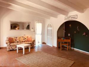 a living room with a couch and a table at Finca Can Jordi in Felanitx