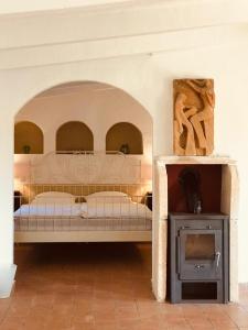 a bedroom with a bed and a fireplace in a room at Finca Can Jordi in Felanitx