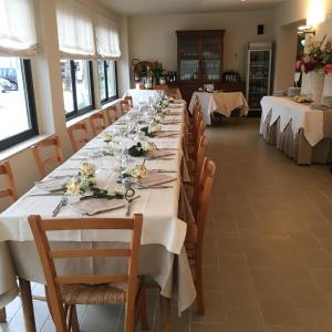 a large dining room with long tables and chairs at Hotel Ristorante Il Gabbiano in Cecina