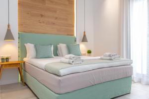 1 dormitorio con 1 cama con cabecero azul en Korali Palace Hotel, en Naxos Chora