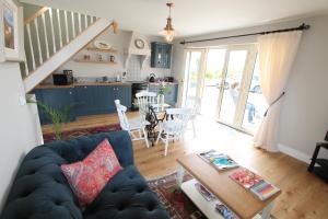 ein Wohnzimmer mit einem blauen Sofa und einem Tisch in der Unterkunft Atlantic Garden Lodge in Lisdoonvarna