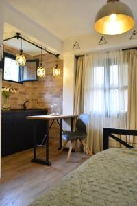 a bedroom with a table and a dining room at Apartman L&M in Cetinje