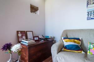 a living room with a couch and a table at Casas do Bárrio in Alcobaça