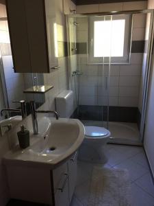 a bathroom with a sink and a toilet and a shower at Apartments Đurđa - amazing location in Sali