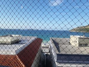 a view of the ocean from the roofs of houses at Dom Yargo II in Arraial do Cabo