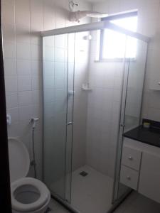 a bathroom with a glass shower with a toilet at Dom Yargo II in Arraial do Cabo +6 photos