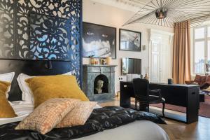 a living room with a bed and a fireplace at Lydmar Hotel in Stockholm