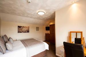 A bed or beds in a room at Kinderton House Hotel 